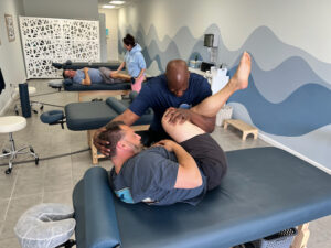 Kwesie Brown, co-founder of StretchSPOT performs therapy on a client.