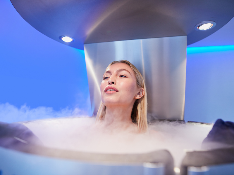 Portrait of young woman in a whole body cryotherapy chamber.