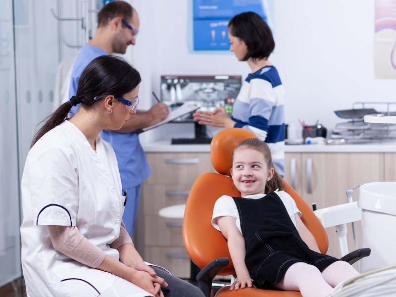 Young female patient in dental office with female dentist